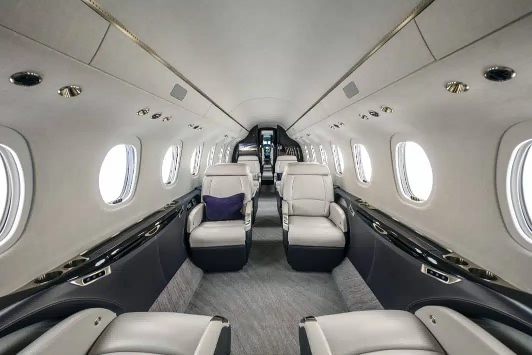 the inside of a private airplane with white walls and white seats