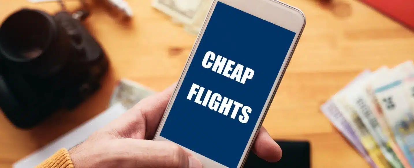 Mobile phone displaying "Cheap Flights" highlighting the accessibility of affordable private jet booking. Start your search for cheap private jet travel today.