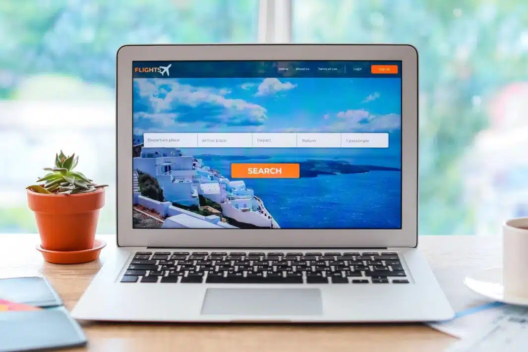Open page of online booking service on screen of laptop on table