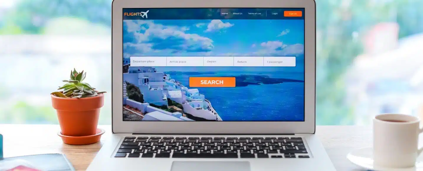 Open page of online booking service on screen of laptop on table