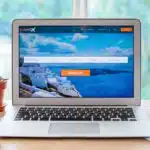 Open page of online booking service on screen of laptop on table