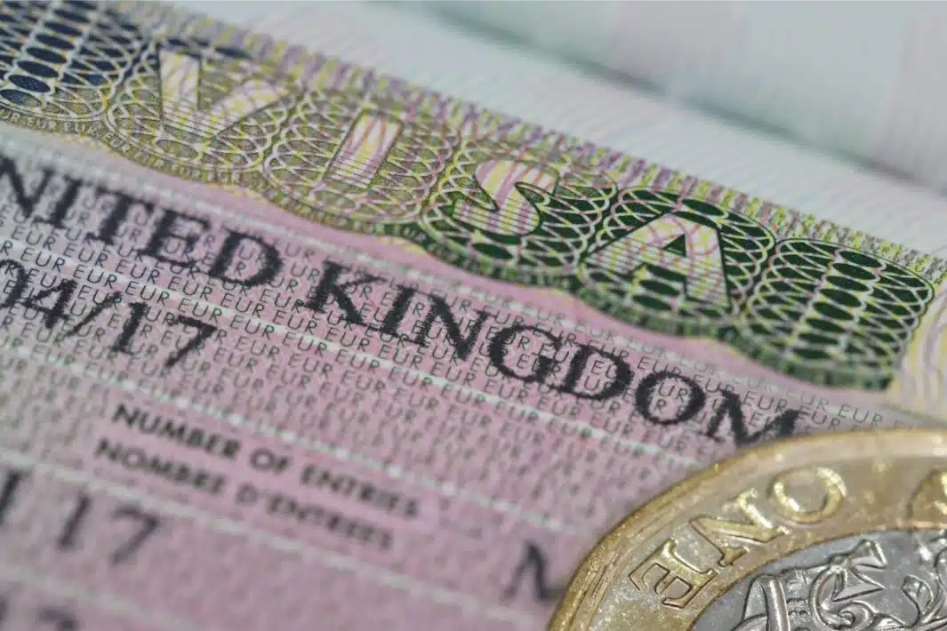 United Kingdom visa in the passport with one pounds coin