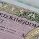 United Kingdom visa in the passport with one pounds coin