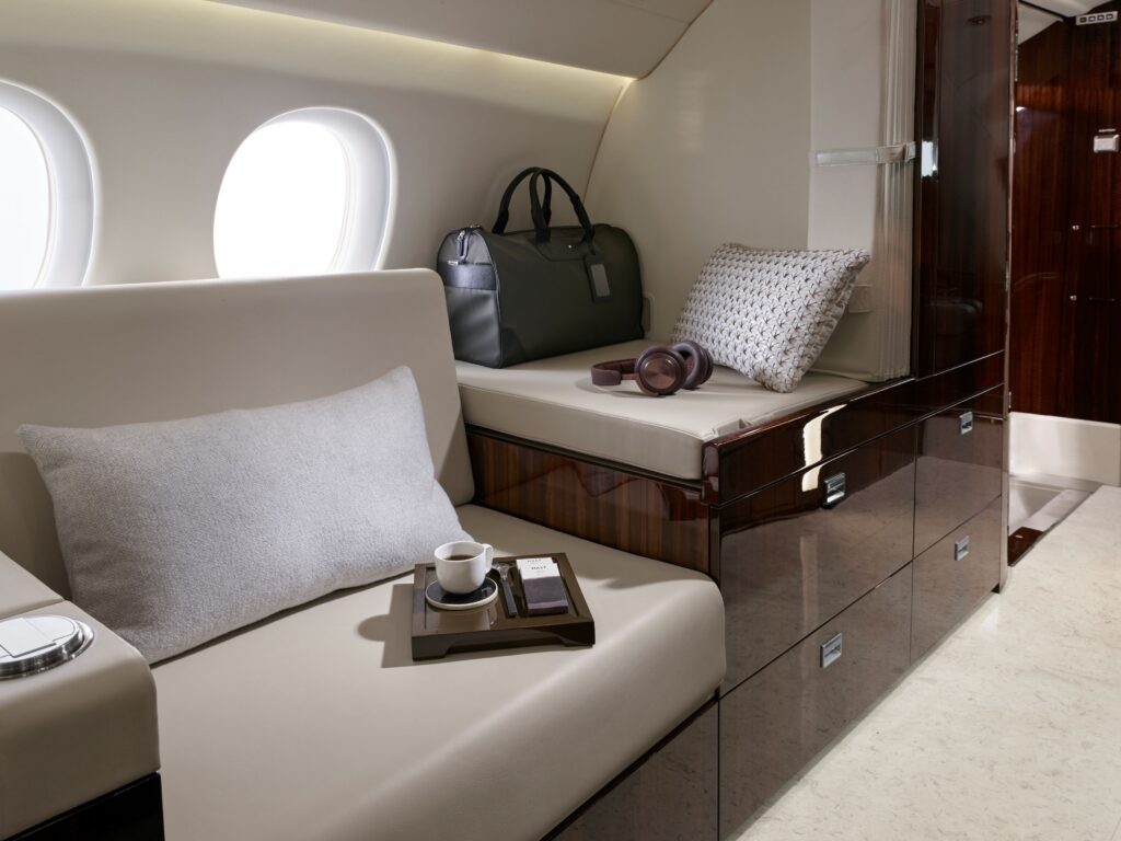 Close-up of a luxury leather club seat in a private jet interior featuring a fresh cup of coffee on the side table; emphasizing comfort and personalized service.