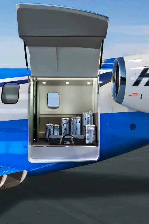 Pilatus PC-24 business jet with rear cargo door open on the left side of the fuselage.